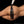 Load image into Gallery viewer, A nude woman’s back and ass are shown against a black background. She lies on her side, and an invisible hand holding a white Neon Wand with the Kinklab Electro-Whip Neon Wand® Attachment attached drags the falls over her ass.
